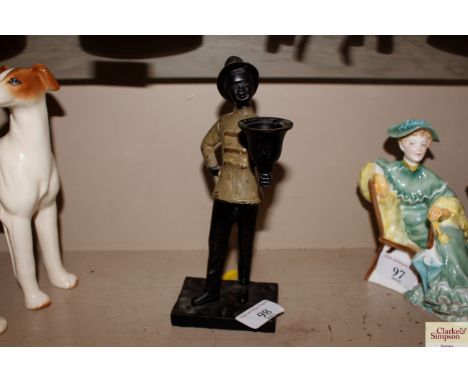 A cold painted spelter figural candlestick