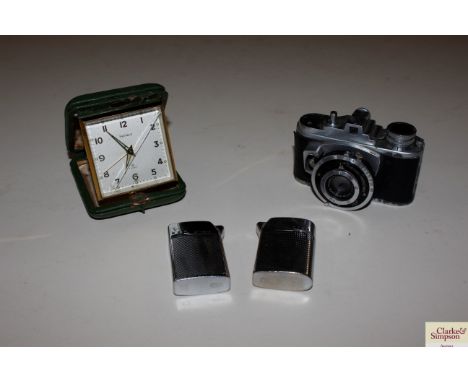 An F.Deckel-Munchen camera; an Helveco alarm clock and two lighters