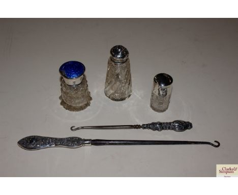 A silver and enamelled top jar; a two silver handled button hooks and two other silver topped jars 