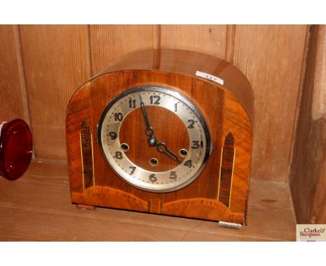 An Art Deco inlaid walnut chiming mantel clock