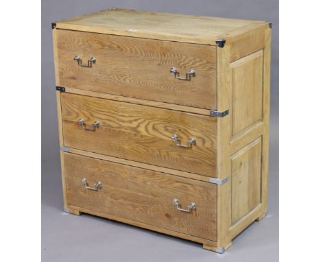 A light oak chest of three long drawers the chromed metal mounts &amp; ditto angular swing handles, on short rectangular bloc