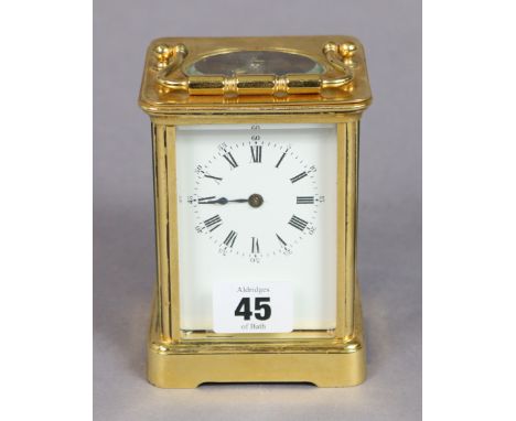 A French brass cased carriage clock with black roman numerals to the white enamel dial, 11.75cm high. 
