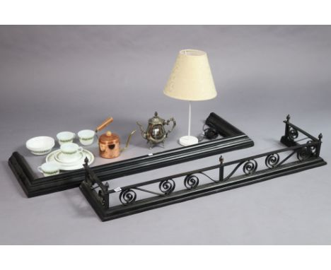 A black-finish cast-iron fender, 132cm long, together with another fender, a table lamp base, with two coffee pots, and a par