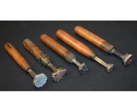 A collection of book binding tools, each matrix with a regimental stamp for leather work, comprising The Kings Royal Rifle Co
