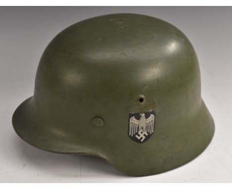 World War Two - Nazi Germany/Third Reich - a M35 Wehrmacht Stahlhelm helmet, decal tricolour and Reichslader to sides, leathe