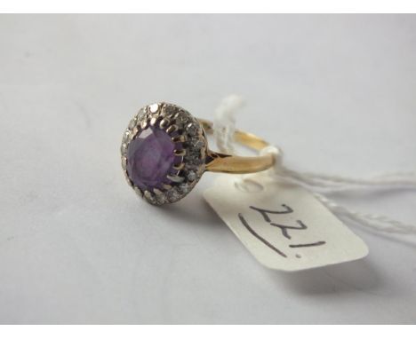 Oval amethyst and diamond bordered cluster ring, set in 18ct. size O/P  