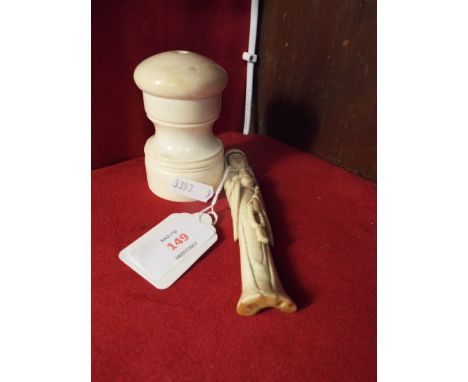 A 19thC ivory pepper grinder together with a Japanese carved bone figure of a deity