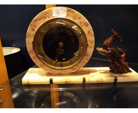An Art Deco circular marble mantel clock on rectangular base flanked by a leaping deer