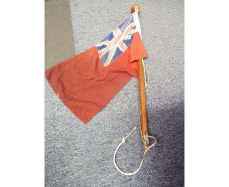 A vintage boating flag depicting a Union Jack on a red background