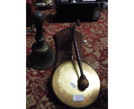 A 1930s brass gong in the form of a German Shepherd together with a vintage hand bell with turned wooden handle