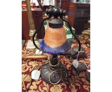 An Art Nouveau style table lamp having pink and blue flared glass shade