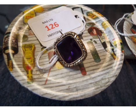 A foiled amethyst brooch with chased gold mount and closed back