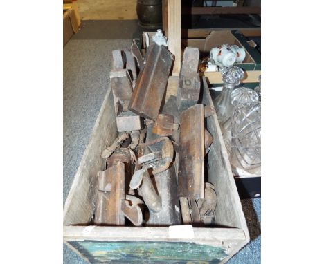 A selection of wooden planes, spoke shaves, whet stones etc housed in a vintage pine Blue Anchor 'Out of the West' packing cr