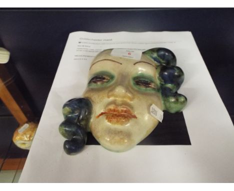 A 1930s Goldscheider wall mask depicting a beautiful female face, marks to back     13cm high x 14xm across at the widest poi