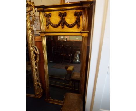 A George III rectangular gilt pier mirror, the beaded cornice over ribbon bow swags and central plate flanked by fluted pilas