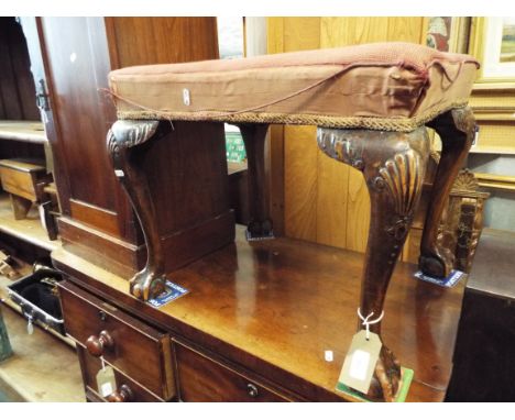 A Victorian mahogany footstool having tapestry upholstery resting on carved cabriole supports