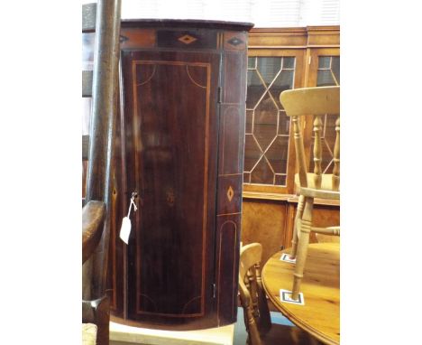 A Georgian mahogany line inlaid chequer strung bow fronted corner cabinet