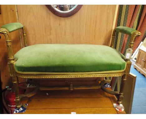 An early 19thC French gilt duet stool, the padded arms above an overstuffed seat raised on fluted acanthus carved supports an
