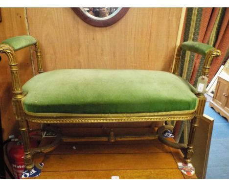 An early 19thC French gilt duet stool, the padded arms above an overstuffed seat raised on fluted acanthus carved supports an