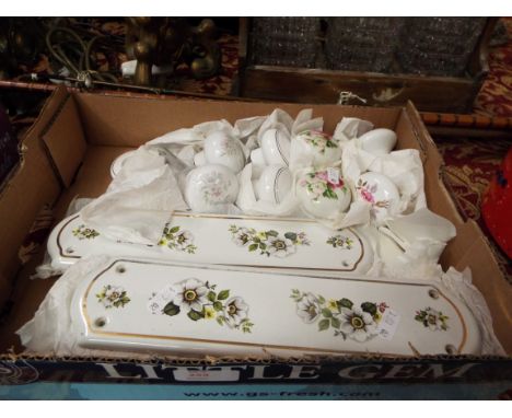 A selection of ceramic floral door knobs and finger plates