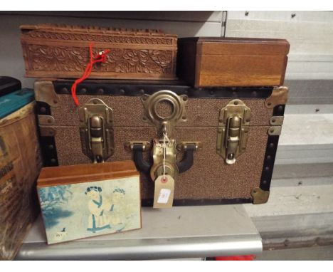 A small metal bound shipping trunk, a floral carved hardwood jewellery box and two other boxes