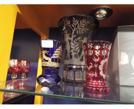 A deep ruby red flash glass vase wheel engraved with classical maiden together with two smaller