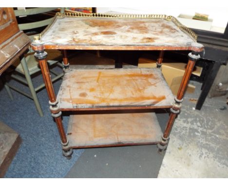 A 19thC crossbanded and ebony inlaid walnut three tier whatnot with brass three-quarter gallery and finials raised on turned 