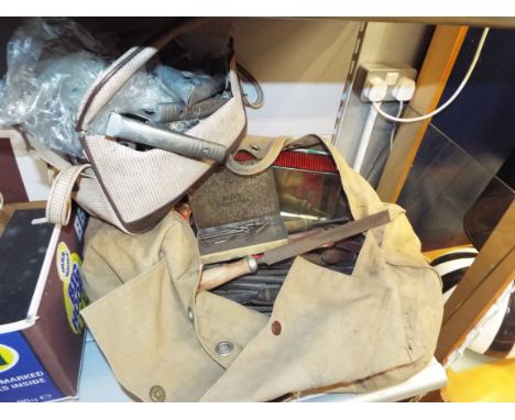 A tool bag containing vintage engineer's tools to include wrenches, files, screw drivers, drill and lathe bits etc
