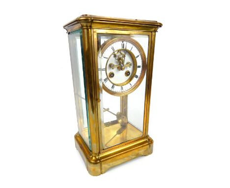 A 19th / early 20th century French brass four glass mantle clock, with white enamel dial, black painted Roman numerals the ch