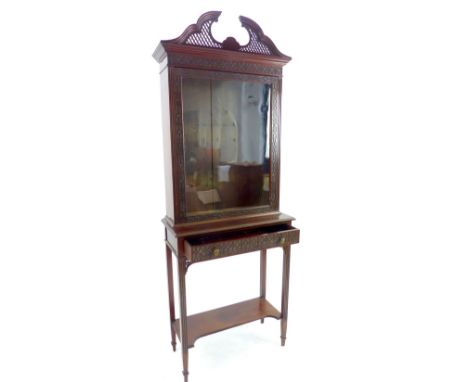 19th Century cabinet on stand of Thomas Chippendale design, fretwork swan neck pediment, geometric border to glazed cabinet o