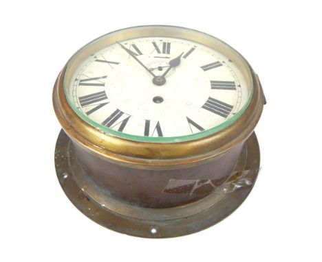 A large 19th / early 20th century circular brass ships clock, the white painted enamel dial, with black painted Roman numeral