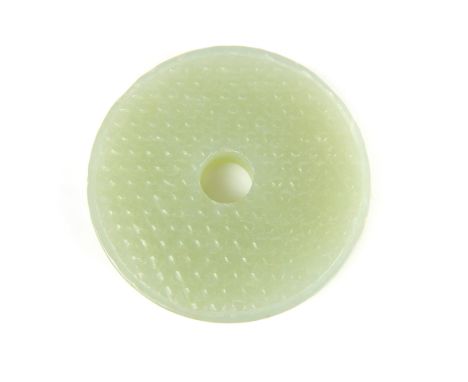 A carved Chinese jade bi - disc, carved to simulate silk worm skin, 5.5cm diameter