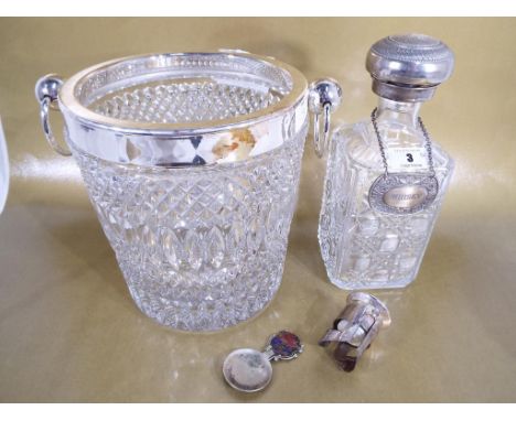 A very heavy good quality cut glass ice bucket with twin handles and white metal mount, a whisky decanter with white metal st