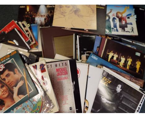 A large quantity of 33.3 rpm vinyl record albums to include Abba, Grease, Diana Ross, Michael Jackson, Wet Wet Wet, Billy Joe