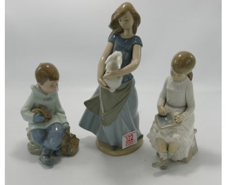 Three Nao figurines: girl holding a rabbit, girl writing and a boy sitting down with a rabbit (3) 