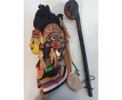 A Indian themed wooden puppet and wooden club