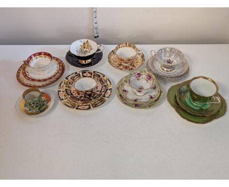 A selection of assorted cups and saucers including Noritake, Royal Crown Derby and Royal Worcester, shipping unavailable