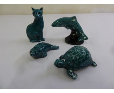 Four Poole Pottery figurines, a cat, a tortoise, a seal and a fish