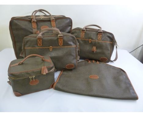 A quantity of Mulberry leather luggage to include a suitcase, two holdalls, a suit bag and a vanity case