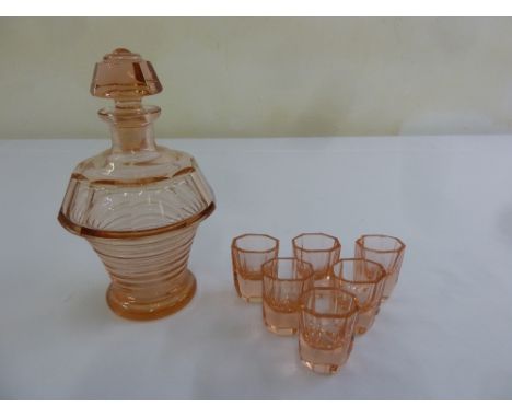 An Art Deco pink glass decanter with drop stopper and six matching shot glasses