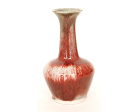  A Cobridge Pottery Stoneware high fired vase of globe and shaft form with a red sang de beouf type glaze, impressed mark, he