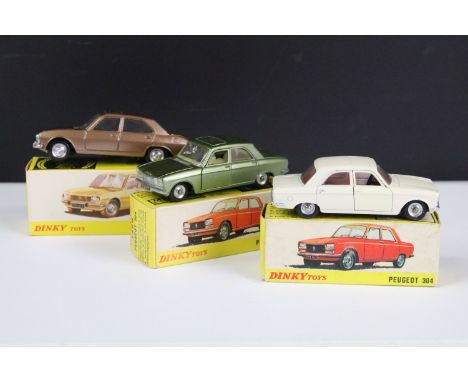 Three boxed French Dinky diecast models to include 1428 Peugeot 304 Saloon in metallic green with creamy white interior, silv