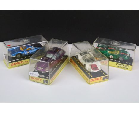 Four cased Dinky diecast models to include 216 Ferrari Dino in metallic blue, black engine cover tan interior and silver hubs