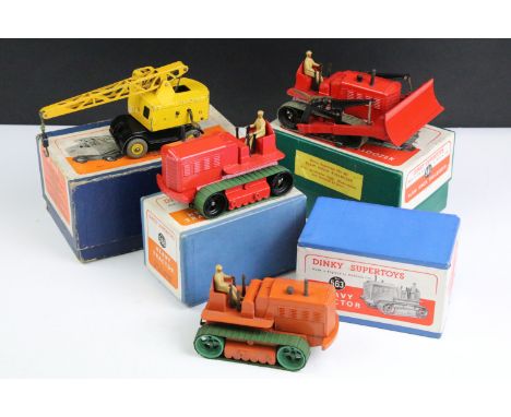 Four boxed Dinky Supertoys diecast models to include 2 x 563 Heavy Tractor (one in red with green tracks and one in orange wi