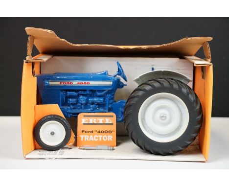 Boxed ERTL Ford 4000 Tractor diecast model in blue, complete with exhaust stack still sealed in packaging, model showing some