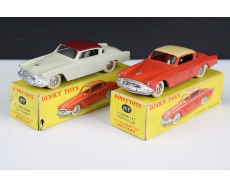 Two boxed French Dinky 24Y Studebaker Commander diecast models, one in dark orange / coral with cream roof, silver trims and 