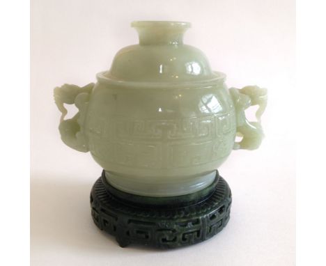 A beautiful example of a lidded white jade censer and cover on an ornate stand. Dragon carved handles. Body of censer is carv