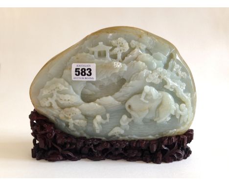 A Large Chinese Pale Celadon Jade Boulder. Beautiful, carved with Chinese scenery on both sides sitting on a carved stand 18/