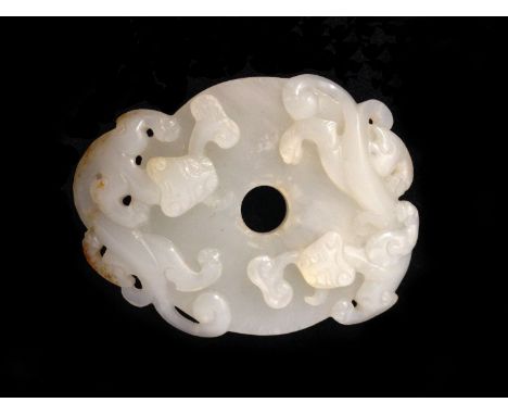 A White Jade Pendant Carving of a Dragon 18/19th Century. 6.6cm