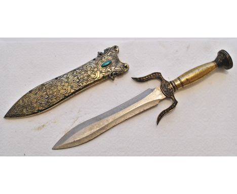 A 20th Century fantasy Chinese dagger having a brass handle with flared decorated pommel, double forward facing quillons, a s